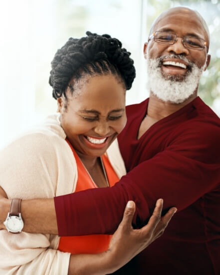 Older couple smiling and hugging